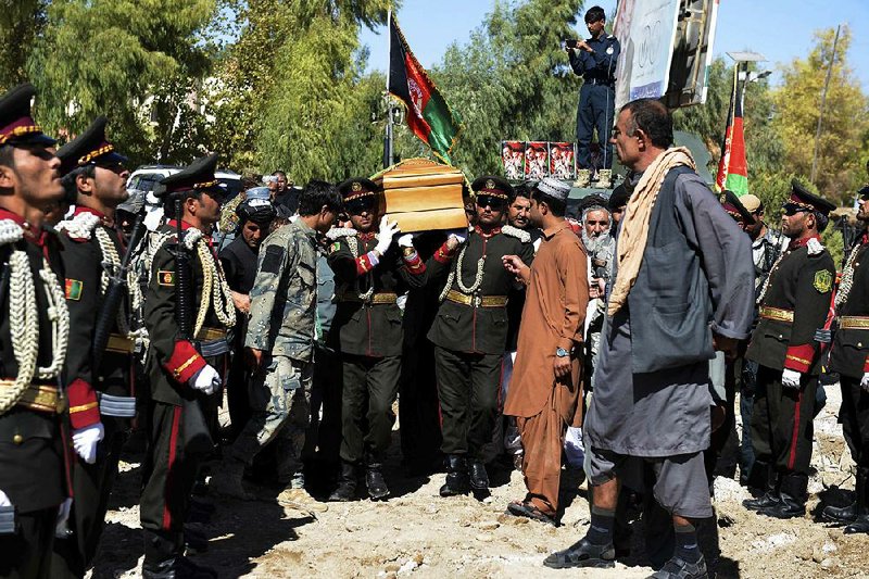 Guards of honor carry the coffin of Gen. Abdul Raziq, the police chief killed after a security meeting this week, during his funeral Friday in Kandahar, Afghanistan.