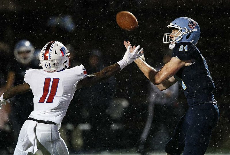 Pulaski Academy tight end Hudson Henry (right) tries to pull in a pass against Little Rock Parkview defender Gaaiylon Finley (11) during the third quarter of the Bruins’ 43-14 victory over the Patriots on Friday. For more high school football photos, visit arkansasonline.com/galleries.