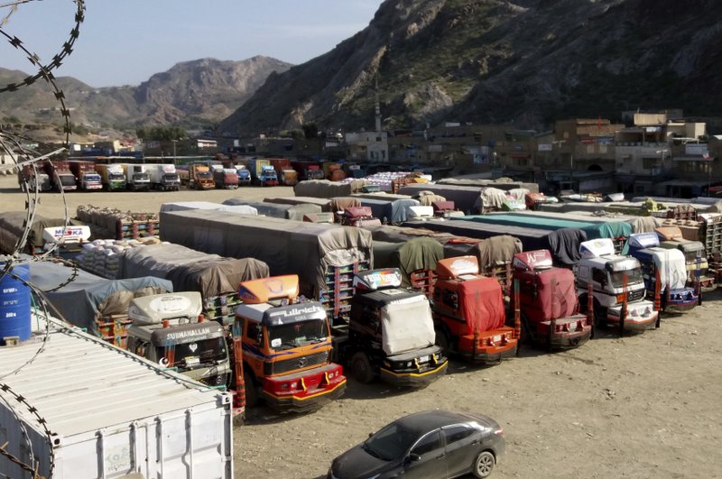 Trucks are parked at Pakistan-Afghanistan border Torkham, Friday, Oct. 19, 2018. Pakistan closed its two official border crossings with Afghanistan, the foreign ministry said. The development came at the request of the Afghan government, which routinely accuses Pakistan of harboring Taliban militants, a charge Islamabad denies. The crossings would remain closed Friday and Saturday. (AP Photo/Qazi Rauf)