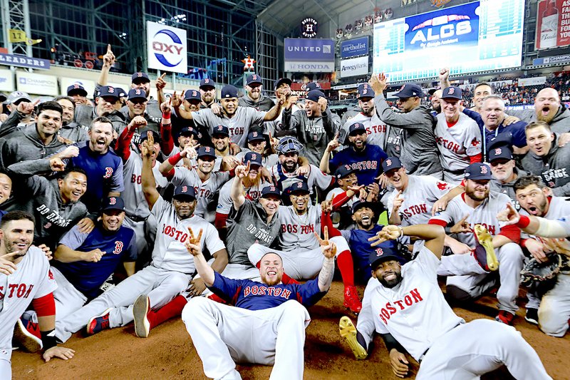 The Boston Red Sox pose for a picture after winning the baseball American League Championship Series against the Houston Astros on Thursday, Oct. 18, 2018, in Houston. Red Sox won 4-1. (AP Photo/David J. Phillip)