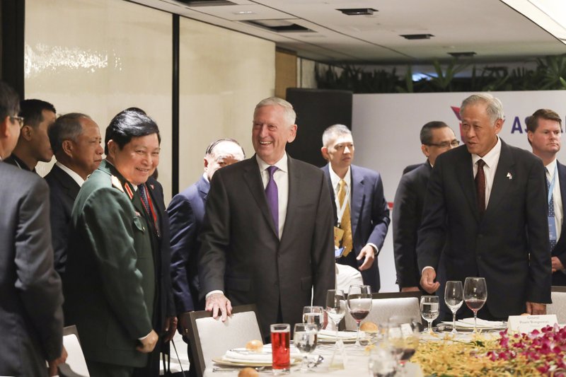 U.S. Defense Secretary Jim Mattis, center, and Singapore's Defense Minister Ng Eng Hen, front right, attend an informal lunch meeting with defense ministers at ASEAN Defense Ministers' Meeting in Singapore Friday, Oct. 19, 2018. (AP Photo/Don Wong)