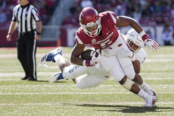 Arkansas running back Rakeem Boyd tries to run out of a tackle attempt by a Tulsa defender during a game Saturday, Oct. 20, 2018, in Fayetteville. 