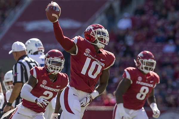 Arkansas defensive lineman Randy Ramsey (10) runs off the field with the ball after recovering a fumble during a game against Tulsa on Saturday, Oct. 20, 2018, in Fayetteville. 