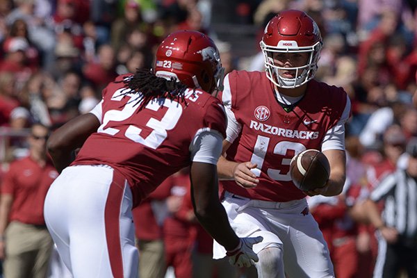 Arkansas quarterback Connor Noland hands the ball to running back Maleek Williams (23) during a game Saturday, Oct. 20, 2018, in Fayetteville. 