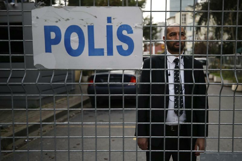 A security guard looks out Saturday from the road leading to the Saudi Arabian Consulate in Istanbul. 