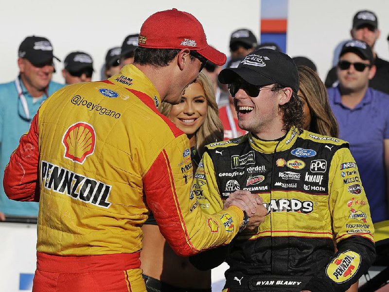 Ryan Blaney (right) is congratulated by Joey Logano in victory lane after winning the NASCAR Cup series race Sept. 30 at Charlotte Motor Speedway in Concord, N.C. Blaney has high hopes for his chance to make the cut in today’s Hollywood Casino 400 elimination race at Kansas Speedway. Logano will start from the pole.