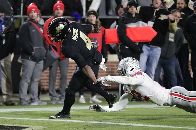 Purdue wide receiver Rondale Moore (4) breaks a tackle by Ohio State safety Isaiah Pryor to score a touchdown Saturday during the Boilermakers’ 49-20 victory over the No. 2 Buckeyes at West Lafayette, Ind.