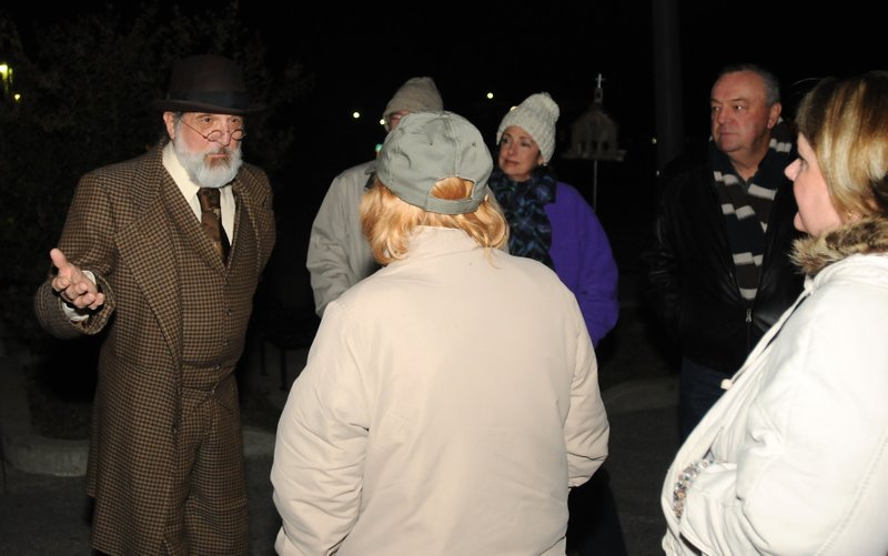 File Photo John Ford, playing B.F. Sikes, explains the death of Will Dalton to participants during a previous Ghost Walk hosted by the Rogers Historical Museum. This year's tales will be told Oct. 24-26.