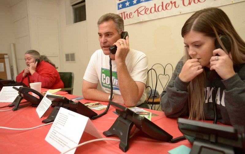 NWA Democrat-Gazette/ANDY SHUPE State Rep. Charlie Collins (center), R-Fayetteville, makes calls to voters Saturday with Bailey Janssen (right), field director for the party, and longtime volunteer Sunny O'Neal of Fayetteville at the Washington County Republican Party headquarters in Fayetteville.