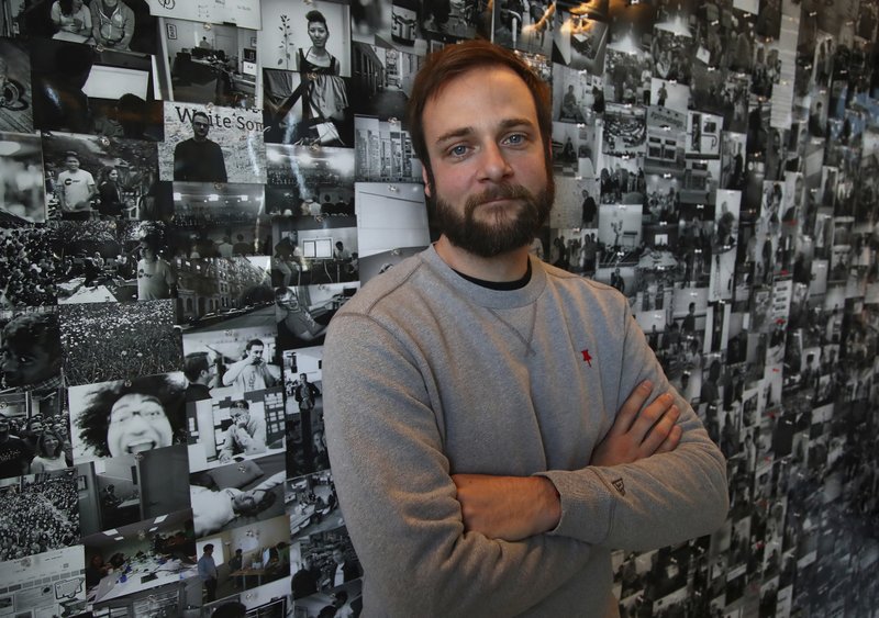 In this Thursday, Oct. 11, 2018, photo Evan Sharp, Pinterest co-founder and chief product officer, poses for a photo in his office beside a wall of pinned photos he has taken at Pinterest headquarters in San Francisco. &#x201c;Social media is about sharing what you are doing with other people,&#x201d; said Sharp. &#x201c;Pinterest isn't about sharing. It's mostly about yourself, your dreams, your ideas you want for your future.&#x201d; (AP Photo/Ben Margot)