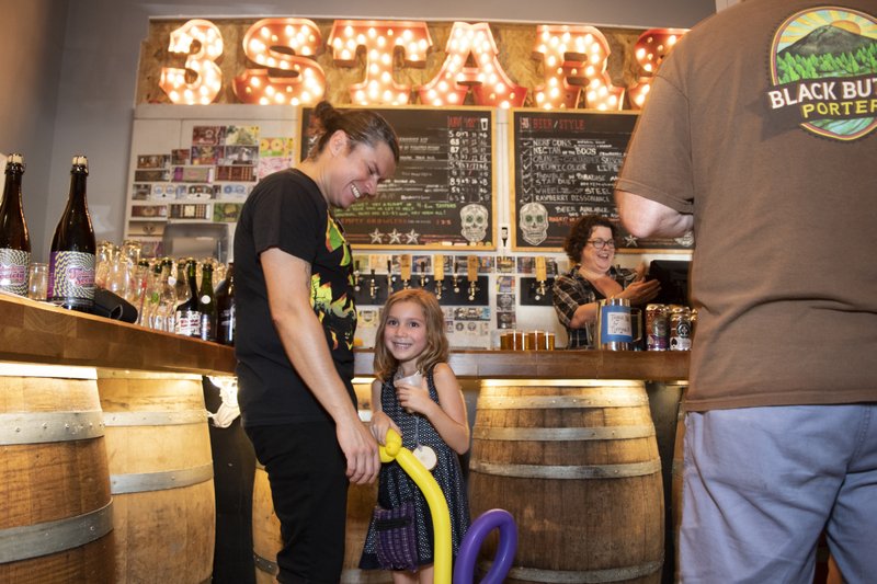 Juan Fonseca and his 6-year-old daughter, Abigail, spend a Sunday afternoon at 3 Stars Brewing in Northwest Washington. MUST CREDIT: Washington Post photo by Marvin Joseph