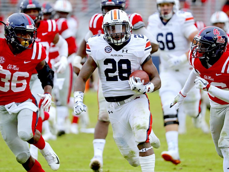 Auburn running back JaTarvious Whitlow (28) runs past Mississippi defenders towards the goal line, before fumbling the ball into the end zone, during the second half of an NCAA college football game on Saturday, Oct. 20, 2018, in Oxford, Miss. Auburn recovered the fumble for a touchdown and won 31-16. (AP Photo/Rogelio V. Solis)