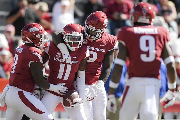 Arkansas Razorbacks defensive back Ryan Pulley (11) reacts after intercepting a pass intended for Tulsa Golden Hurricane wide receiver Keylon Stokes (2) during the second quarter of a football game, Saturday, October 20, 2018 at Donald W. Reynolds Razorback Stadium in Fayetteville.