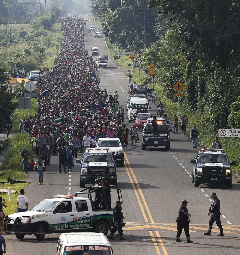 Central American migrants leave Ciudad Hidalgo, Mexico, on Sunday and continue their walk to the United States. Despite efforts by Mexican officials to stop them, about 5,000 migrants headed for the U.S. border. 