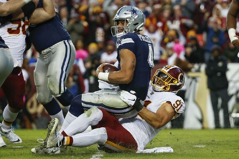 Washington Redskins linebacker Ryan Kerrigan sacks Dallas Cowboys quarterback Dak Prescott during the fourth quarter Sunday in Landover, Md. It was one of four sacks by the Redskins as they won 20-17 for their second consecutive victory.