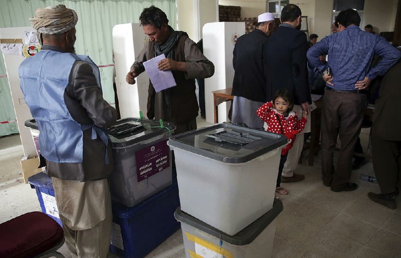 A man prepares to cast his vote during the second day of parliamentary elections in Kabul, Afghan- istan, on Sunday.