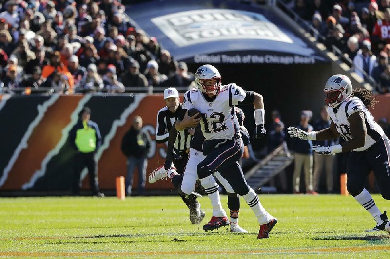 New England quarterback Tom Brady (12) threw for three touch- downs in leading the Patriots to a 38-31 victory over the Chicago Bears on Sunday at Soldier Field.