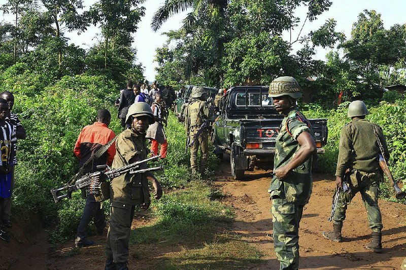 Congolese soldiers patrol in an area where civilians were killed by Allied Democratic Forces rebels in Beni, Eastern Congo. Congolese military said Sunday that the rebels also abducted about a dozen children.