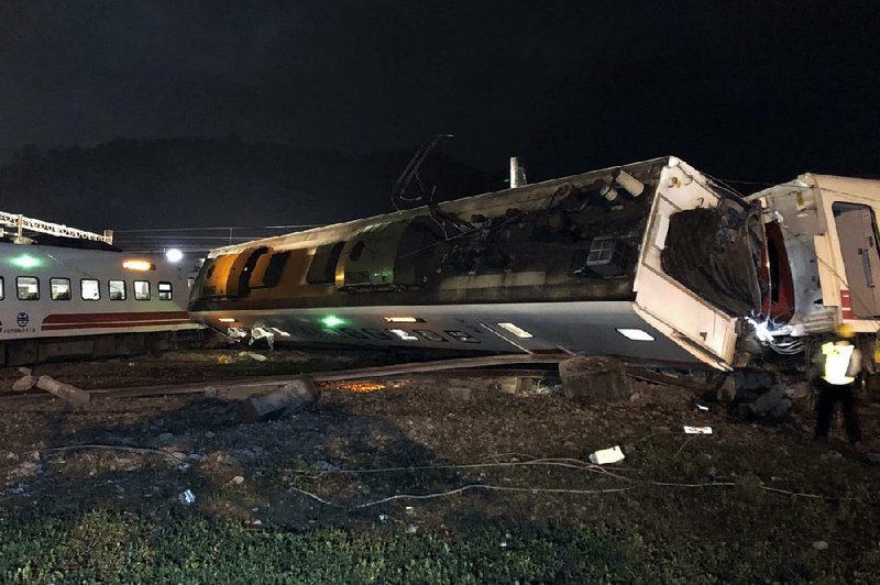 Train cars are scattered at the site of a derailment in Yilan County in northern Taiwan on Sunday in this photo released by Taiwan Railways Administration.