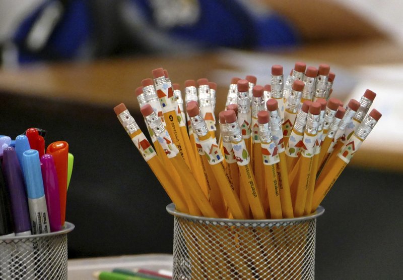 FILE- In this July 24, 2017, file photo, pencils are at the ready on a teachers desk at Bruns Academy in Charlotte, N.C. The Educator Expense Deduction is a $250 tax deduction to help recoup out-of-pocket costs for outfitting a classroom, getting training or buying teaching materials. (Davie Hinshaw/The Charlotte Observer via AP, File)