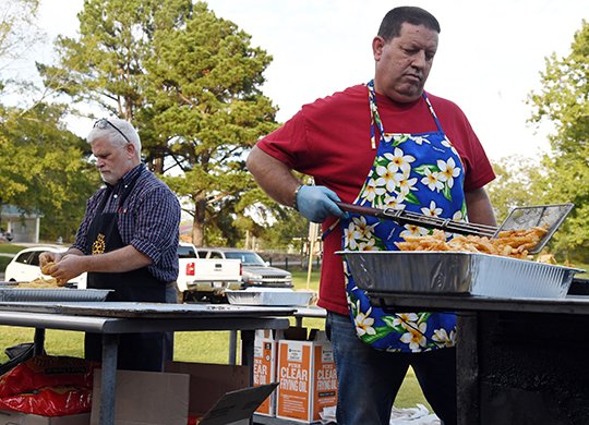 The Sentinel-Record/Grace Brown - Sunrise Rotarians Thomas Moore, left, and Rick Hatton work prepare catfish filets and sides for the Sunrise Rotary&#x201a;&#xc4;&#xf4;s annual fish fry fundraiser at Family Park on Thursday. This year, benefits from the fish fry went to CASA and Ouachita Children&#x201a;&#xc4;&#xf4;s Center. 