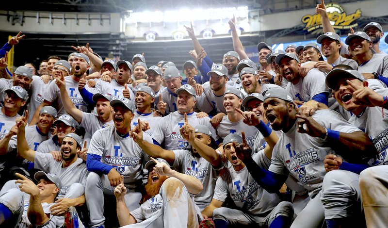 The Los Angeles Dodgers celebrate after Game 7 of the National League Championship Series baseball game Saturday, Oct. 20, 2018, in Milwaukee. The Dodgers won 5-1 to advance to the World Series. (AP Photo/Jeff Roberson) 