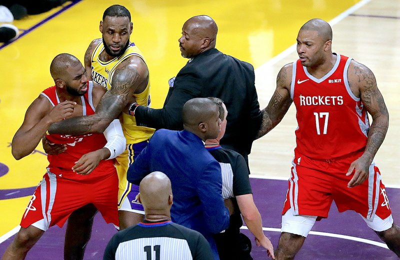 Houston Rockets' Chris Paul, left, is held back by Los Angeles Lakers' LeBron James, second from left, after Paul's fight with Lakers' Rajon Rondo during the second half of an NBA basketball game Saturday, Oct. 20, 2018, in Los Angeles. (AP Photo/Marcio Jose Sanchez)