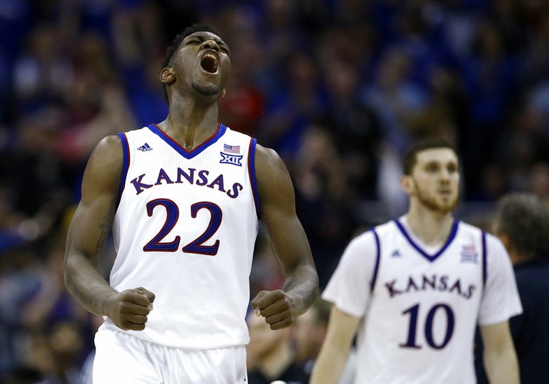 In this March 10, 2018, file photo, Kansas' Silvio De Sousa (22) celebrates during the second half of the NCAA college basketball championship game against West Virginia in the Big 12 men's tournament, in Kansas City, Mo. Kansas is ranked No. 1 in The Associated Press preseason Top 25 poll released Monday, Oct. 22, 2018. (AP Photo/Charlie Riedel, File)