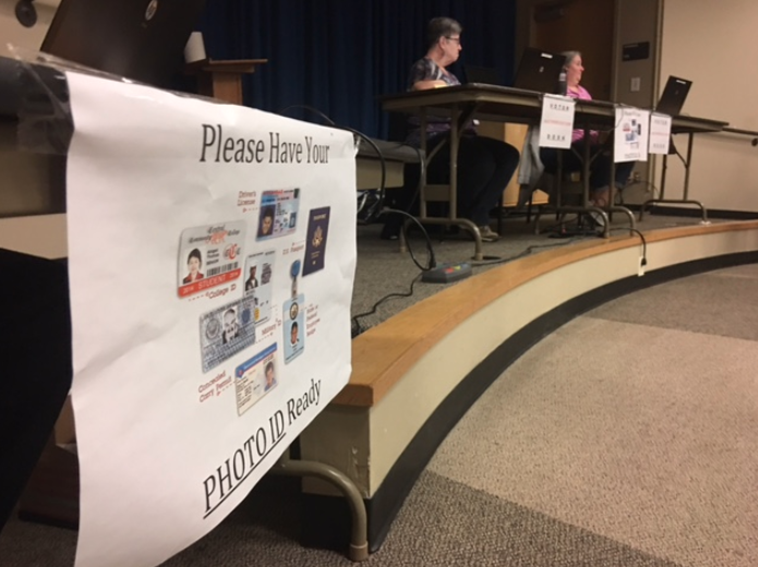 A sign at an early voting location at Laman Library at North Little Rock instructs voters that they must show identification to cast ballots.