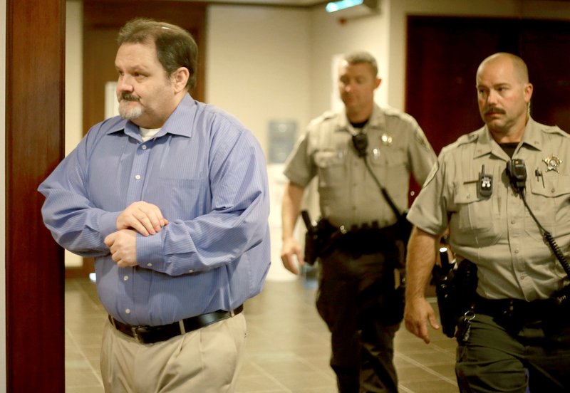 Mark Edward Chumley is escorted Monday, October 22, 2018, into the courtroom at the Washington County Courthouse in Fayetteville. Chumley was found guilty of capitol murder last Friday for the torture and brutal killing of a Fayetteville woman in 2015.