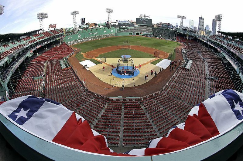 A look at Boston’s Fenway Park from the upper deck as Red Sox players work out Sunday. The Red Sox host the Los Angeles Dodgers in Game 1 of the World Series tonight.