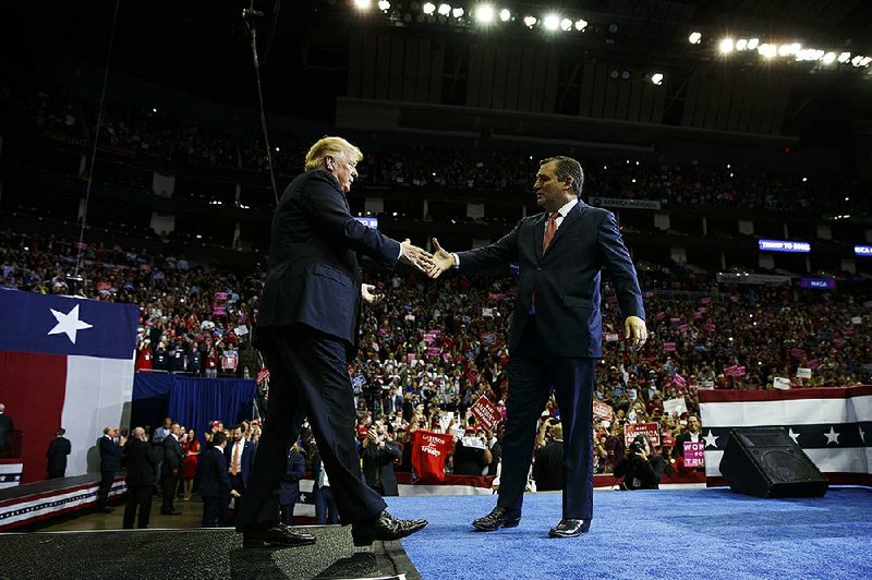 President Donald Trump is greeted by Sen. Ted Cruz, R-Texas, during a campaign rally Monday night at the Toyota Center in Houston.