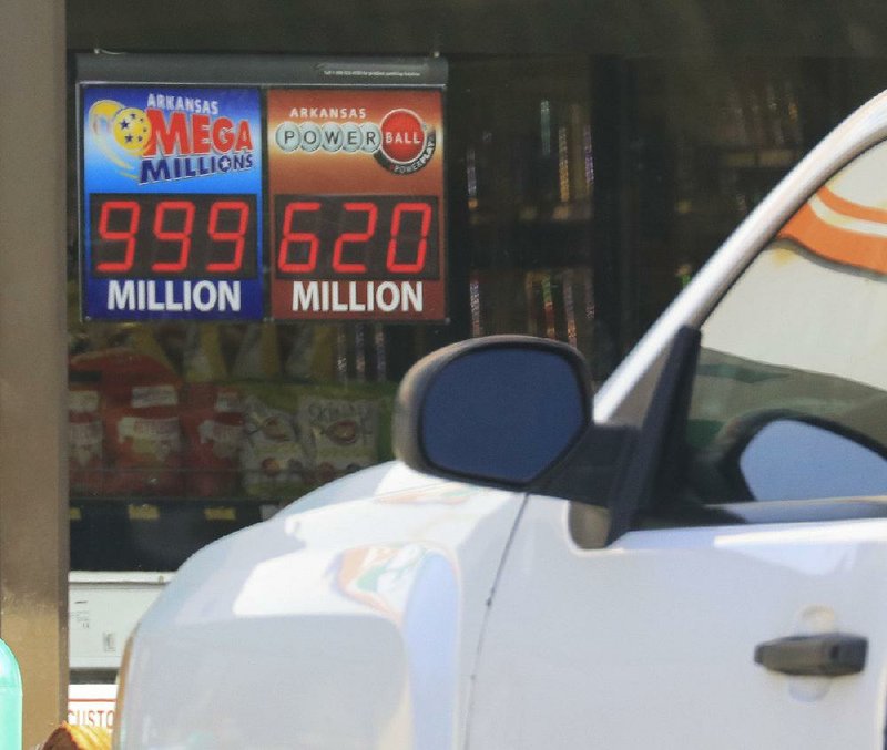 A sign in the window of a Little Rock convenience store doesn’t have enough numbers to give the prize for today’s drawing of the Mega Millions lottery. The Powerball lottery jackpot is displayed next to it. The prize amounts are based on an annuity amount; one-time payoffs are smaller, but still hefty amounts, even after taxes.