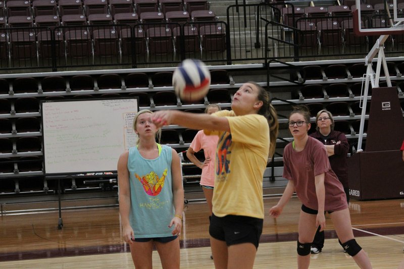 The Sentinel-Record/James Leigh PASS AND GO: Lake Hamilton senior libero Brooke Powell, center, passes the ball Monday during practice at Wolf Arena with teammates Morgan Fincham, left, and Meadow Orrell ahead of the Class 5A state tournament today in Jonesboro.