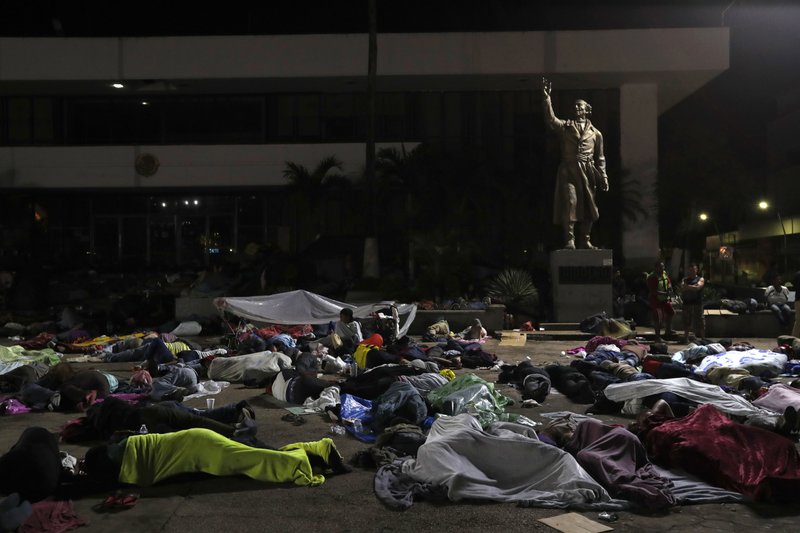 The Associated Press CARAVAN: Honduran migrants hoping to reach the U.S. sleep in the southern Mexico city of Tapachula, Monday, in a public plaza featuring a statue of Mexican national hero Miguel Hidalgo, a priest who launched Mexico's War of Independence in 1810. Keeping together for strength and safety in numbers, some huddled under a metal roof in the city's main plaza Sunday night. Others lay exhausted in the open air, with only thin sheets of plastic to protect them from ground soggy from an intense Sunday evening shower.
