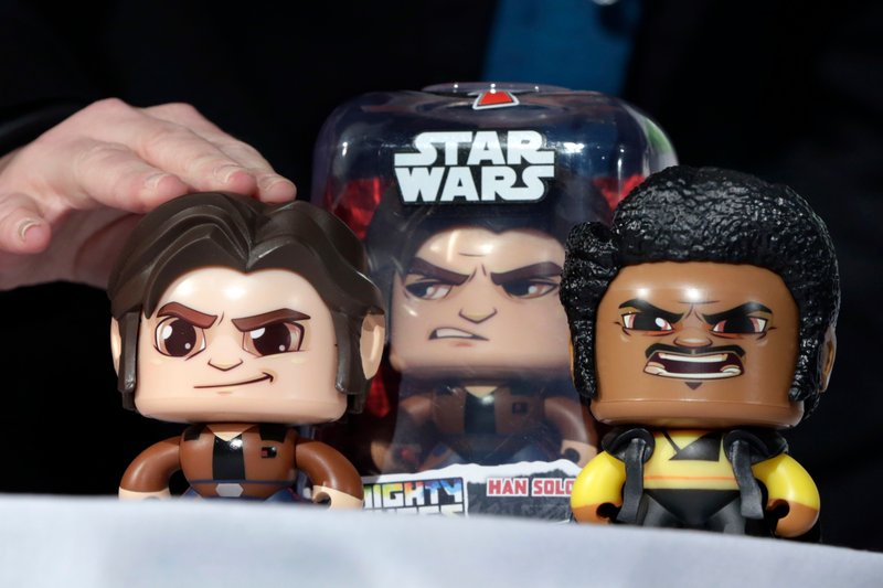 FILE - In this April 26, 2018, file photo, the Star Wars Hans Solo Mighty Muggs, by Hasbro, are demonstrated at the TTPM 2018 Spring Showcase, in New York. Hasbro Inc. (HAS) on Monday, Oct. 22, reported third-quarter earnings of $263.9 million. (AP Photo/Richard Drew, File)