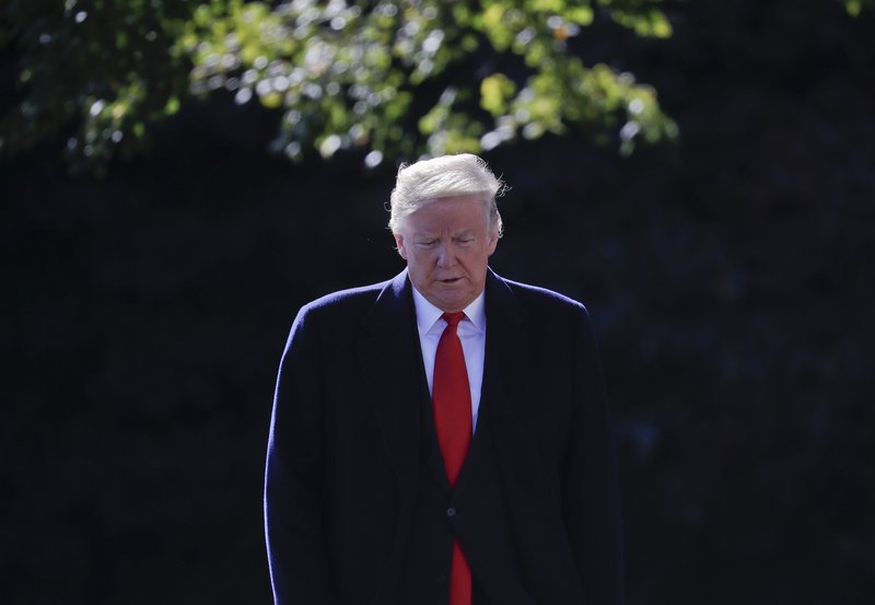 The Associated Press SHORT TRIP: President Donald Trump walks over to talk to members of the media on the South Lawn of the White House in Washington, Monday, before boarding Marine One helicopter for a short trip to Andrews Air Force Base, Md., en route to Houston.