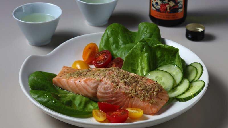 Steamed Salmon is flavored with citrus and sake.