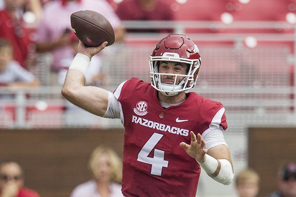 Ty Storey, Arkansas quarterback, gets off a pass as he takes a hit from Christian Miller, Alabama linebacker, in the 1st quarter Saturday, Oct. 6, 2018, at Razorback Stadium in Fayetteville.