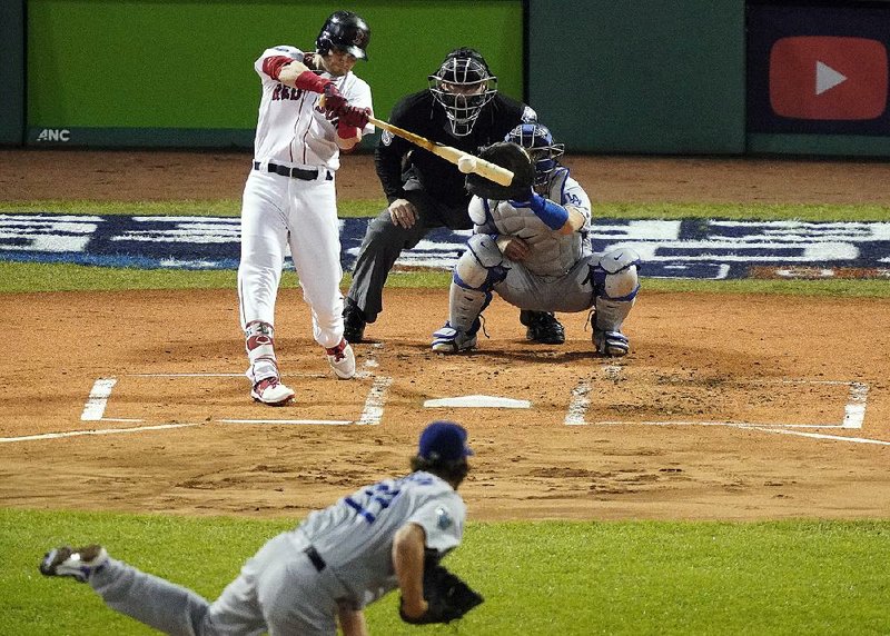 Former Arkansas Razorback Andrew Benintendi of the Boston Red Sox hits an RBI single in the first inning of the Red Sox’s victory over the Los Angeles Dodgers in Game 1 of the World Series on Tuesday night. Benintendi finished 4 for 5, becoming the third Red Sox player to have four hits in a World Series game. 