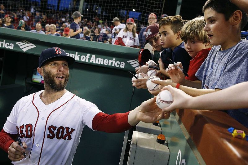 Boston Red Sox's Dustin Pedroia signs autographs between games of the team's doubleheader against the Baltimore Orioles in Boston, Wednesday, Sept. 26, 2018. 
