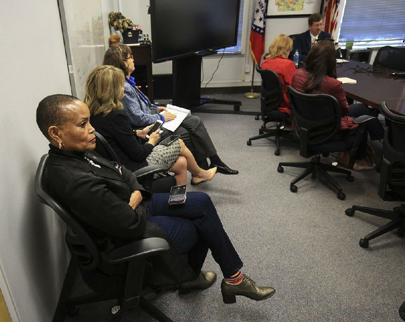 Sen. Joyce Elliott, D-Little Rock, (left) listens with others Tuesday as state Education Commissioner Johnny Key (top, right) discusses his proposed waiver of the state’s Teacher Fair Dismissal Act for selected Little Rock schools after rejecting a contract already approved by the Little Rock teachers’ union. Elliott said afterward that teachers can’t always overcome all the circumstances of “marginalized,” socioeconomically disadvantaged families.