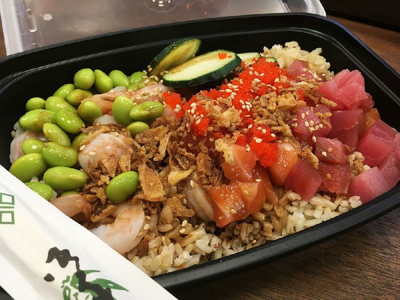 Tuna, salmon and shrimp make up a large poke bowl, topped with edamame, cucumber, masago, crispy onion and sesame seeds, at Fresh Bowl n Roll in the River Market’s Ottenheimer Market Hall.