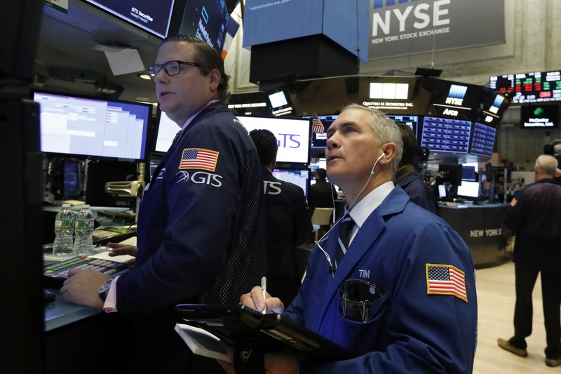 Specialist Gregg Maloney, left, and trader Timothy Nick work on the floor of the New York Stock Exchange, Wednesday, Oct. 24, 2018. Stocks are off to a mixed start on Wall Street as gains for Boeing and other industrial companies are offset by losses elsewhere in the market. (AP Photo/Richard Drew)