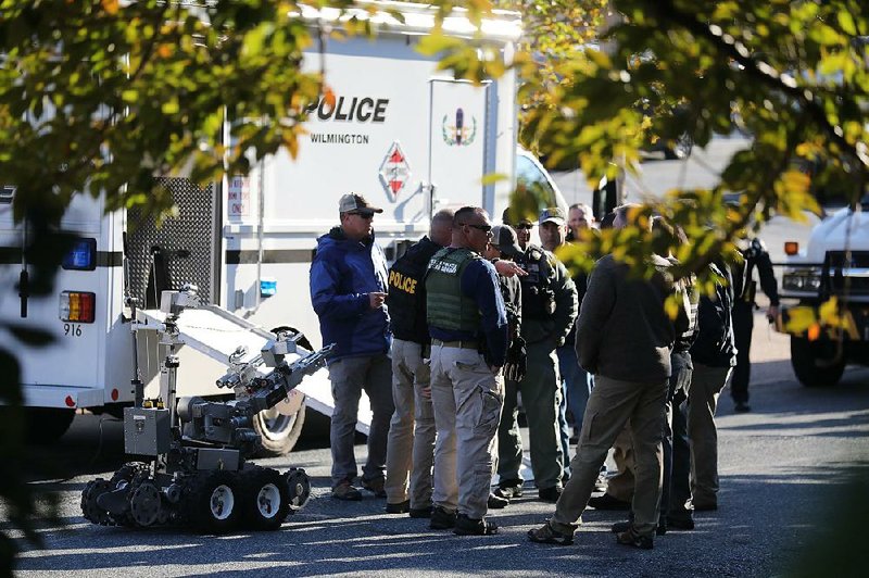 Authorities remove a packaged device from a U.S. Postal Service facility Thursday in Wilmington, Del., that was addressed to former Vice President Joe Biden. Another package addressed to Biden was found at a mail facility in New Castle, Del. 