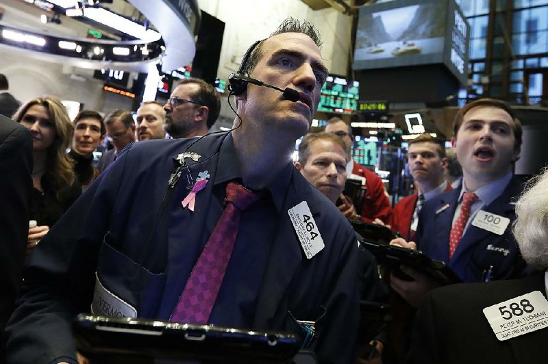 Trader Gregory Rowe takes part in the buying frenzy Thursday at the New York Stock Exchange as stocks regain some earlier losses. 