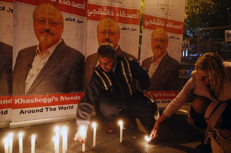 An activist with a group called “Khashoggi’s Friends Around the World” takes part in a candlelight vigil Thursday outside the Saudi Consulate in Istanbul. 