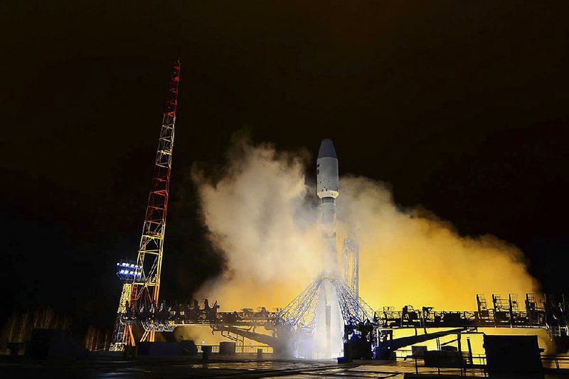 A Russian Soyuz-2 booster rocket lifts off Thursday in northwestern Russia, carrying a military satellite into orbit. 
