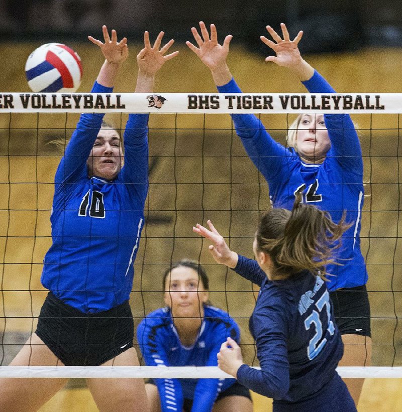 Emma Begley (10) and Anna Haley (12) of Conway try to block a hit by Taylor Rushing of Springdale Har-Ber in the second set Thursday in a Class 6A volleyball state semifinal in Bentonville. The Wampus Cats advanced with a 25-16, 25-19, 25-21 victory.