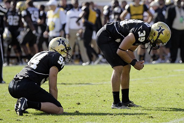 Vanderbilt kicker Carey Spear (39) and holder Richard Kent (94) pause on the field after Spear missed a 27-yard field goal attempt to tie the game against Arkansas with 8 seconds left in the fourth quarter of an NCAA college football game on Saturday, Oct. 29, 2011, in Nashville, Tenn. Arkansas won 31-28. (AP Photo/Mark Humphrey)


